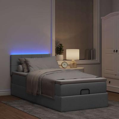 Ottoman bed met matras en LED's 140x200cm stof lichtgrijs