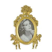 A RESIN PHOTO FRAME FLANKED BY TWO PUTTI