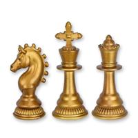 A SET OF 3 RESIN CHESS PIECES - OLD GOLD A SET OF 3 RESIN CHESS PIECES - OLD GOLD