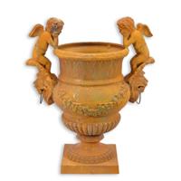 A RUSTY CAST IRON GARDEN URN