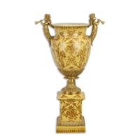 A BRONZE MOUNTED PORCELAIN URN ON BASE