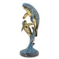 A BRONZE SCULPTURE OF A MANATEE WITH YOUNG A BRONZE SCULPTURE OF A MANATEE WITH YOUNG