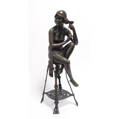 A BRONZE SCULPTURE OF THE CHAMPAGNE LADY