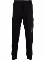 Alexander McQueen pantalon de jogging à logo imprimé - Noir