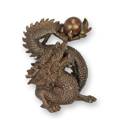 A BRONZE SCULPTURE OF THE PEARL OF WISDOM - BROWN
