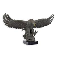 A BRONZE SCULPTURE OF A DESCENDING EAGLE