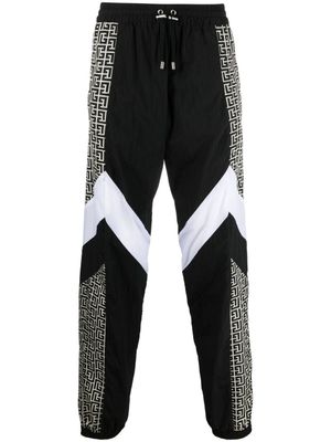 Balmain pantalon de jogging à bandes monogrammées - Noir