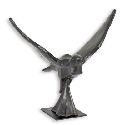 A BRONZE SCULPTURE OF A PIGEON IN FLIGHT