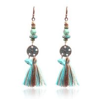 Bronzen oorhangers met muntje, kwastje en turquoise stenen