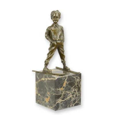 A BRONZE SCULPTURE OF A SKIER BOY