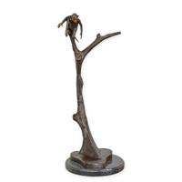 A BRONZE SCULPTURE OF A MONKEY IN A TREE A BRONZE SCULPTURE OF A MONKEY IN A TREE