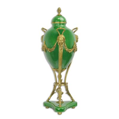 A BRONZE MOUNTED GREEN GROUND JAR AND COVER