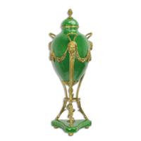 A BRONZE MOUNTED GREEN GROUND JAR AND COVER