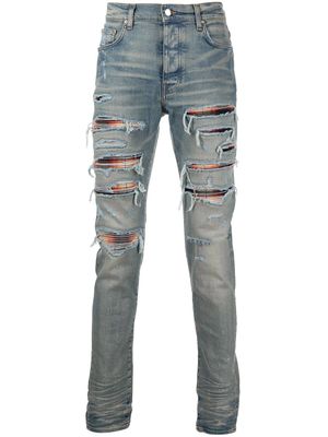 AMIRI jean skinny à effet usé - Bleu