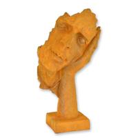A RUSTY CAST IRON FIGURINE "HEAR NO EVIL"