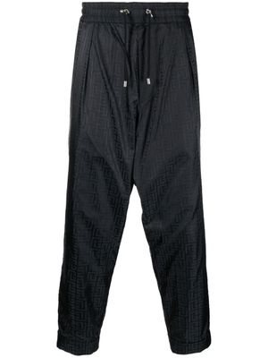 Balmain pantalon fuselé à motif monogrammé - Noir