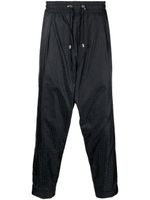 Balmain pantalon fuselé à motif monogrammé - Noir