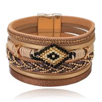 Bruine dames armband met kristal en goudkleurige details - thumbnail