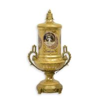 A BRONZE MOUNTED PORCELAIN URN