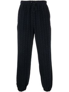 Alexander Wang pantalon de jogging à motif monogrammé embossé - Bleu