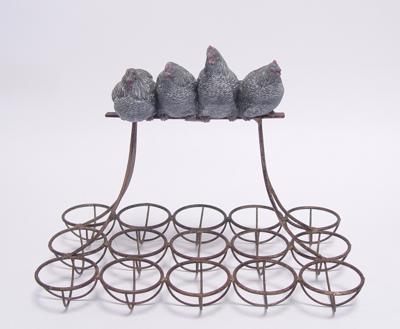 AN IRON EGG RACK MOUNTED WITH RESIN HENS