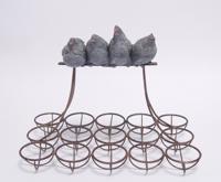 AN IRON EGG RACK MOUNTED WITH RESIN HENS