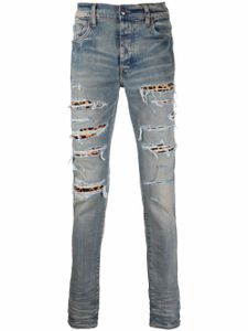 AMIRI jean à finitions effilochées - Bleu