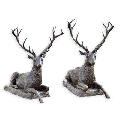 A BRONZE PAIR OF RECLINING DEER
