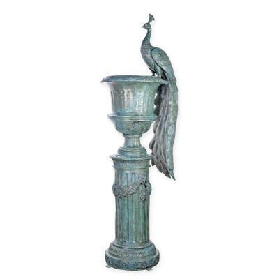 A LARGE BRONZE PEACOCK URN