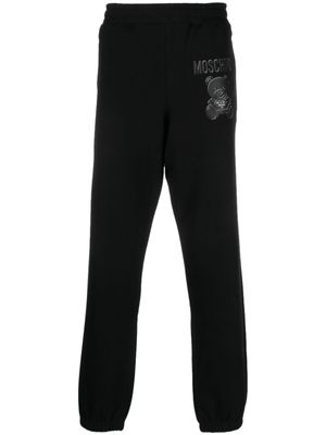 Moschino pantalon de jogging en coton biologique à logo imprimé - Noir