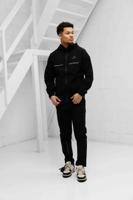 Cruyff Surveyor Trainingspak Heren Zwart - Maat XL - Kleur: Zwart | Soccerfanshop