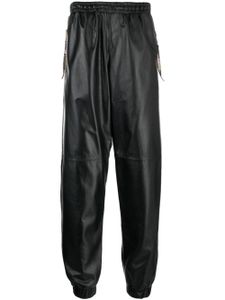 Moschino pantalon de jogging court en cuir - Noir