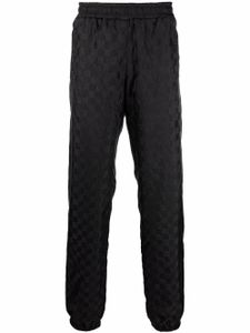 MISBHV pantalon de jogging fuselé motif monogrammé - Noir