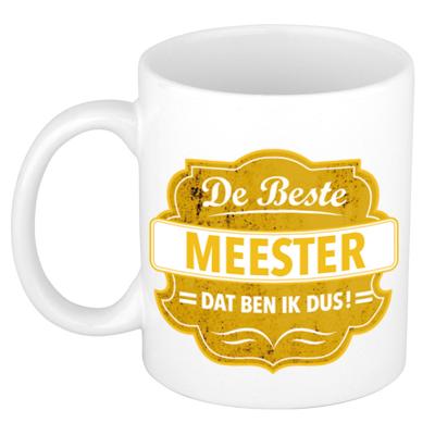 Bellatio Decorations De beste meester koffiemok - cadeau beker - wit - geel embleem - 300 ml Bellatio Decorations De beste meester koffiemok - cadeau beker - wit - geel embleem - 300 ml
