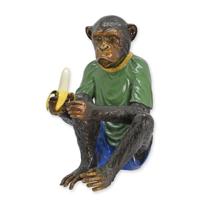 A BRONZE SCULPTURE OF A DRESSED MONKEY EATING A BANANA A BRONZE SCULPTURE OF A DRESSED MONKEY EATING A BANANA