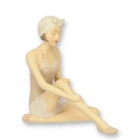 A RESIN FIGURINE OF A RETRO BEACH GIRL A RESIN FIGURINE OF A RETRO BEACH GIRL
