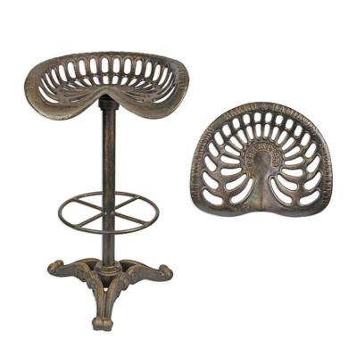 A CAST IRON BAR STOOL, BRONZE COLOUR