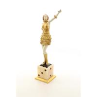 A BRONZE SCULPTURE OF A LADY MOUNTED ON A DICE SHAPED BASE
