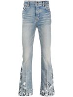 AMIRI jean à effet taches de peinture - Bleu