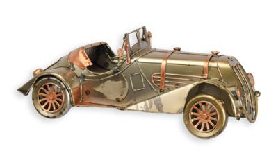 A TIN MODEL OF A CLASSIC CAR