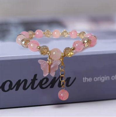 Roze en Goudkleurige Kralenarmband met Vlinder Bedel - Sieraden - Spiritueelboek.nl Roze en Goudkleurige Kralenarmband met Vlinder Bedel - Sieraden - Spiritueelboek.nl