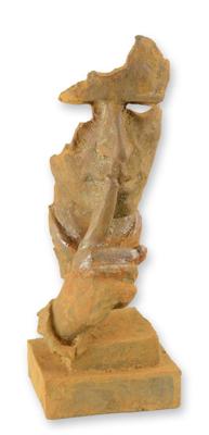 A RUSTY CAST IRON STATUE OF A WHISPERING FACE