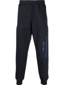 Alexander McQueen pantalon de jogging en coton à imprimé graffiti - Bleu