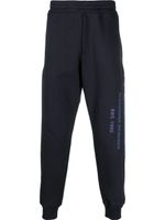 Alexander McQueen pantalon de jogging en coton à imprimé graffiti - Bleu