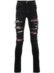 AMIRI jean skinny à finitions effilochées - Noir