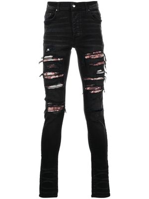 AMIRI jean skinny à finitions effilochées - Noir