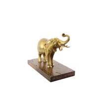 A BRONZE SCULPTURE OF AN ELEPHANT MOUNTED ON A WOODEN PLANK