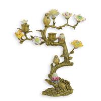 A BRONZE CANDLE STAND MOUNTED WITH PORCELAIN BIRDS