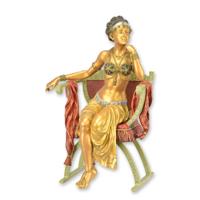 A BRONZE SCULPTURE OF A SEATED BELLY DANCER