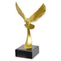 A BRONZE SCULPTURE OF A PIGEON IN FLIGHT